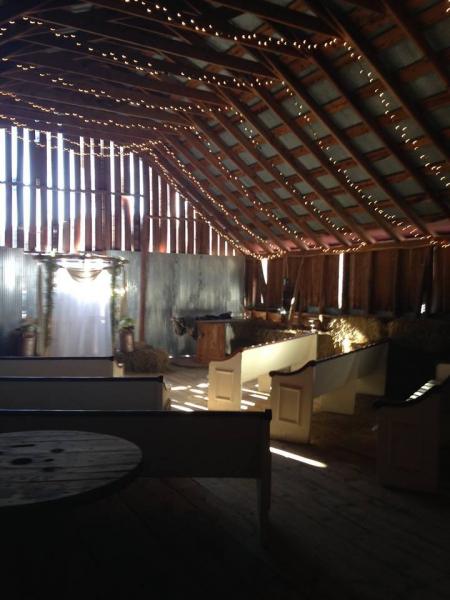 Rustic antique pews provide comfortable seating for Barn Loft Weddings